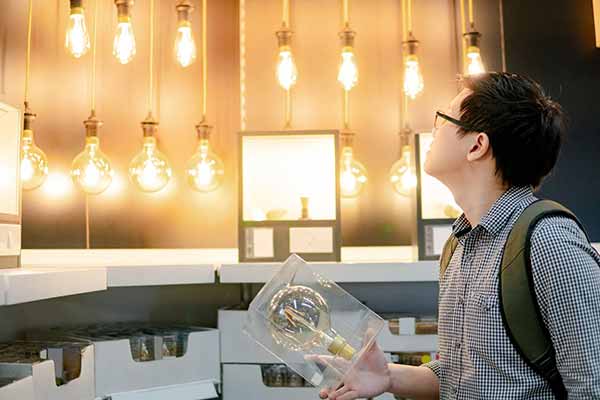 Energy Savings Choosing Best Light Bulb | Boy Holds Bulb