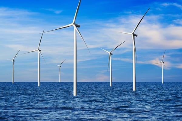 Wind Energy In Ocean as Windmills Hover over Sea