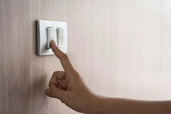 Saving Energy and electricity Woman Touches Switch