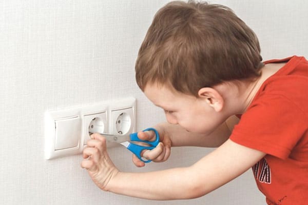 Child Plays with Outlet with Scissors Danger Concerns